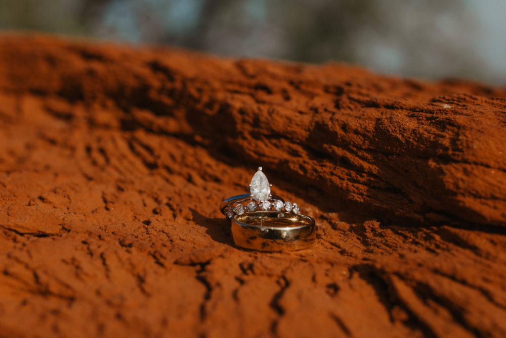 Palo Duro Canyon. Couple gets ready to exchange vows to each other on red rock. ring detail shots