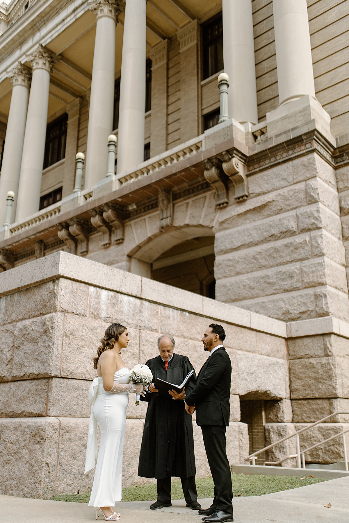man and women saying vows to each other while a Houston elopement photographer takes photos 