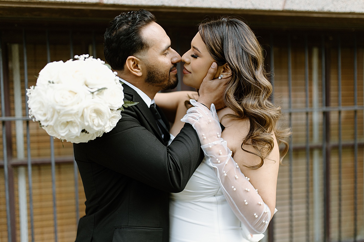 brides hand on grooms face kissing taking photos for a Houston Elopement Photographer