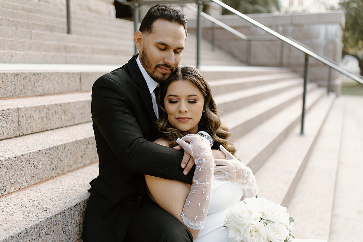 bride and groom sitting on steps of Historic 1910 Courthouse
