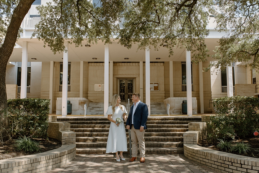 Bride and Groom smiling outside the Conroe Courthouse during elopement captured by a Houston Elopement Photographer