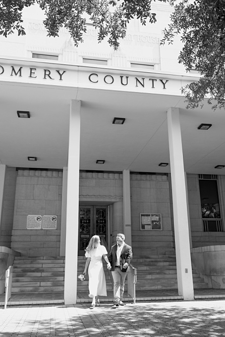 Newlywed couple walking out of the Conroe courthouse, captured by a Houston Elopement photographer.